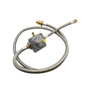 A metal gas regulator with attached flexible hoses lies coiled. The central regulator reads "BROMIC 180L" and includes various fittings, designed for gas system connections in a utilitarian setting.