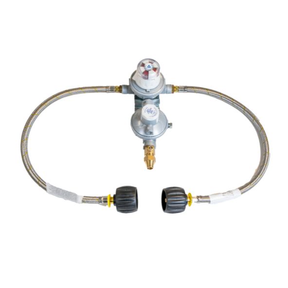 A dual stage gas regulator, connected to two flexible metal hoses with black plastic caps, positioned on a plain white background.