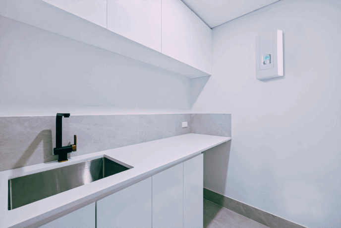 Bromic 3-phase instantaneous electric water heater installed in apartment laundry